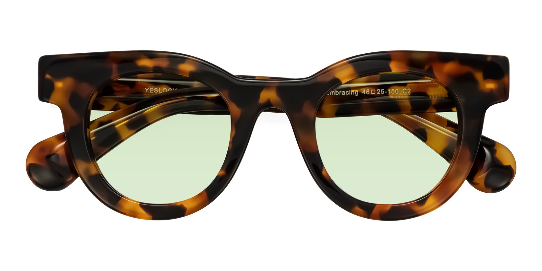 Folded Front of Embracing in Tortoise with Light Green Tinted Lenses