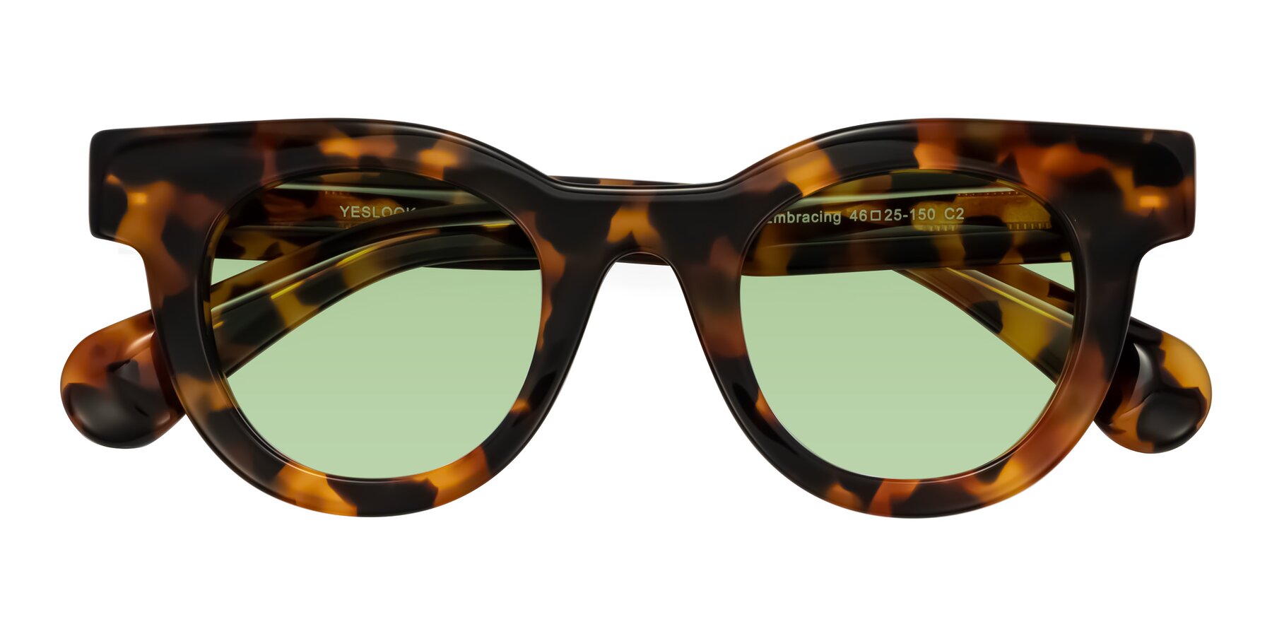 Folded Front of Embracing in Tortoise with Medium Green Tinted Lenses