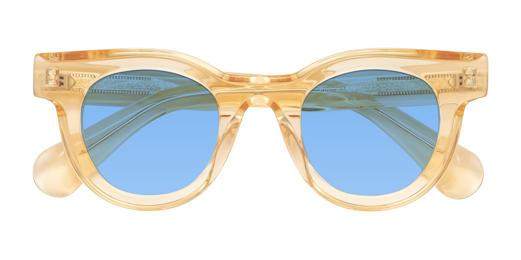 Folded Front of Embracing in Champagne with Medium Blue Tinted Lenses